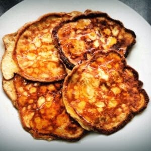 plate of four pancakes with rice syrup drizzled.
