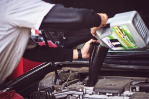 pouring oil into a car engine